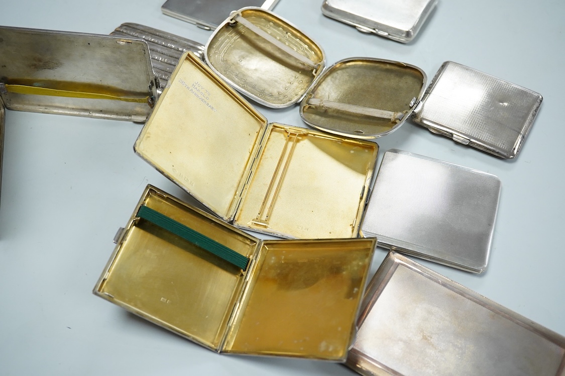 Nine assorted silver cigarette cases, including an Edwardian ribbed case and an engine turned rectangular case by Garrard & Co, Birmingham, 1960, 12.7cm, 32.1oz and one other unmarked white metal cigarette case.